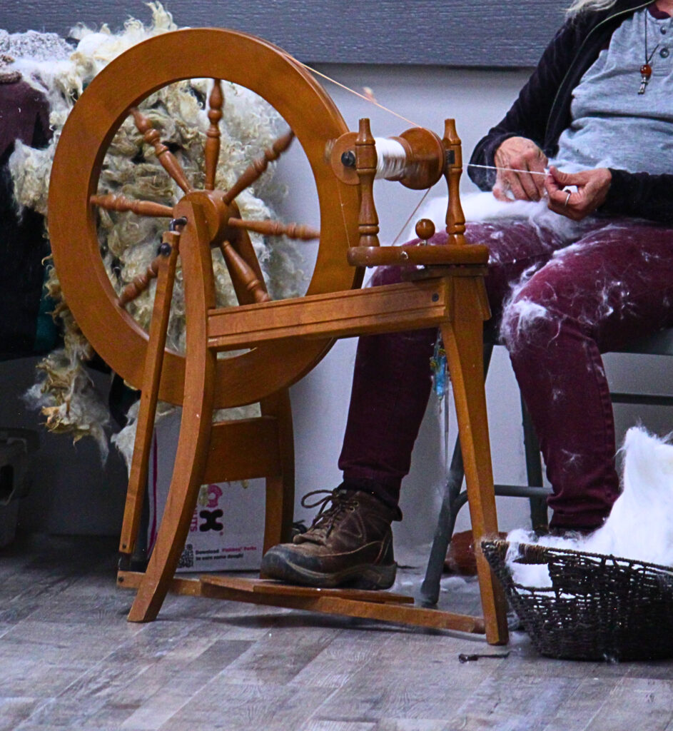 Woman using spinning wheel at 2024 Pahrump Fall Festival