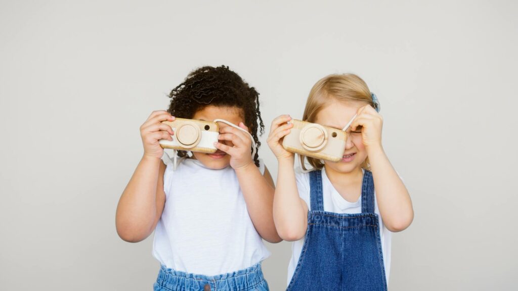 Two girls with toy cameras