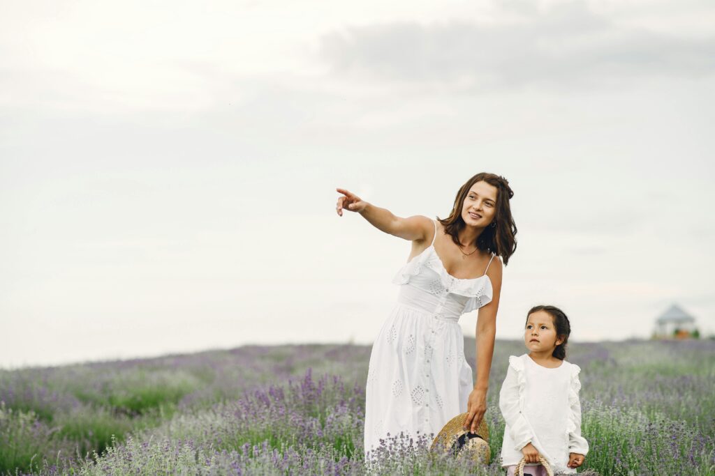 mom and child in field of flowers