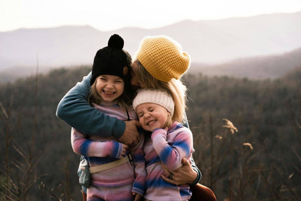 mom hugging daughters