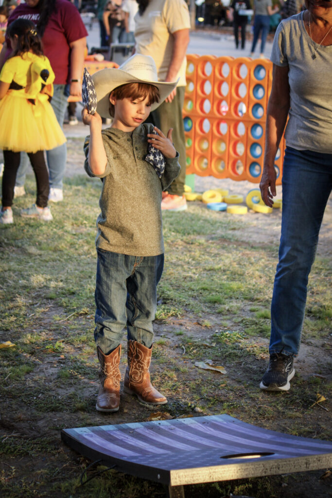 child playing games at pahrumpkin patch at green life produce