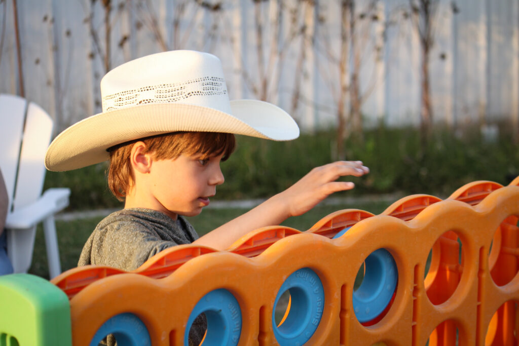 child playing games at pahrumpkin patch at green life produce