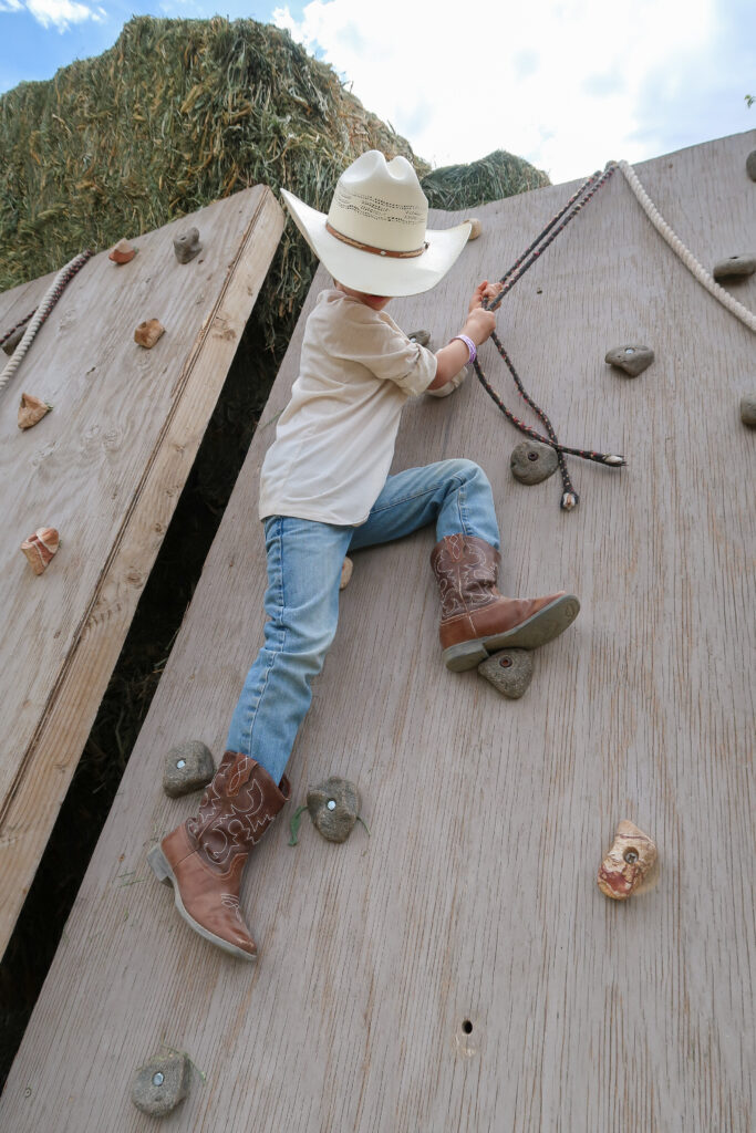 child climbing rock wall